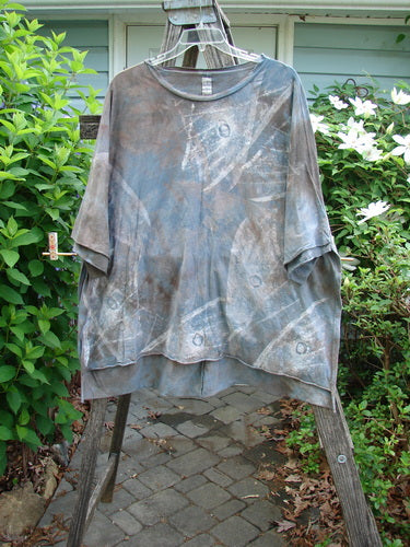 Barclay Raw Edge Flutter Collar High Low Top features a distinct batiste flutter neckline and raw edge detailing, showcased in a wide, boxy shape with a hi-low hem, embodying Bluefishfinder.com's vintage style.