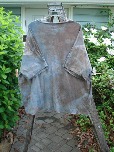 Barclay Raw Edge Flutter Collar High Low Top in Wind Storm theme, featuring a rounded flutter neckline, short raw edge dolman sleeves, and a wide boxy shape with a hi-low hemline.