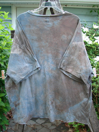 Barclay Raw Edge Flutter Collar High Low Top in Wind Storm Mottled Grey Night OSFA, featuring a rounded flutter neckline, short dolman sleeves, wide boxy shape, and raw-edged hi-low hemline.