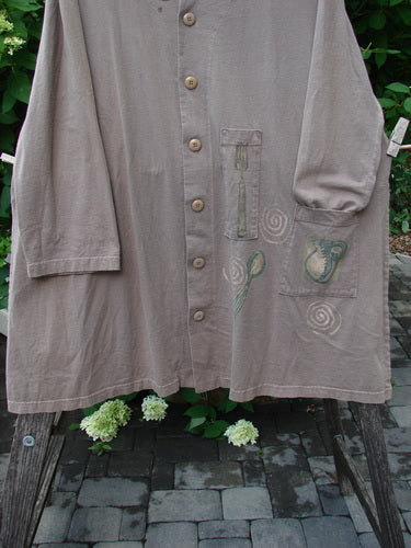 1999 Silverware Top Reverse Dining Riverbed OSFA: A taupe knee-length smock with wooden buttons, green appliqué designs, vented sides, and blue fish patch, showcasing vintage Blue Fish Clothing's creative individuality.