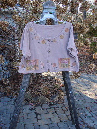 1993 Travel Top Lilly Pads Dried Rose Size 2 displayed on a hanger, featuring a deeply scooped neckline, crop shape, water lily design, Blue Fish 93 patch, and rare wooden buttons.
