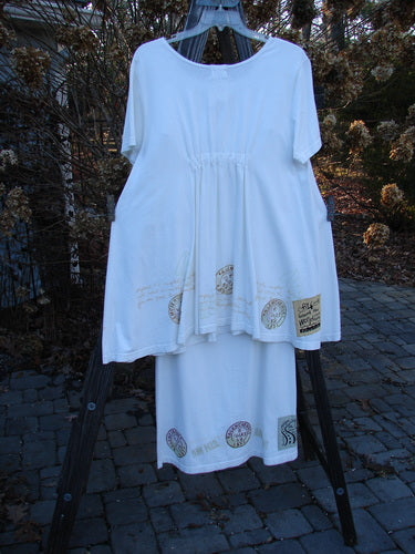 2000 NWT June Straight Duo Postage White Dress and Skirt Set. A white dress with a wider neckline and front pouch pocket, paired with a matching straight skirt. Made from organic cotton.