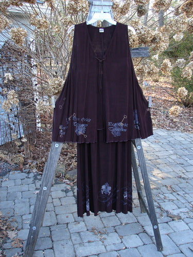 1999 Acetate Streamer Moonbeam Duo Key Deep Burgundy Size 1: A lovely purple dress on a wooden stand.