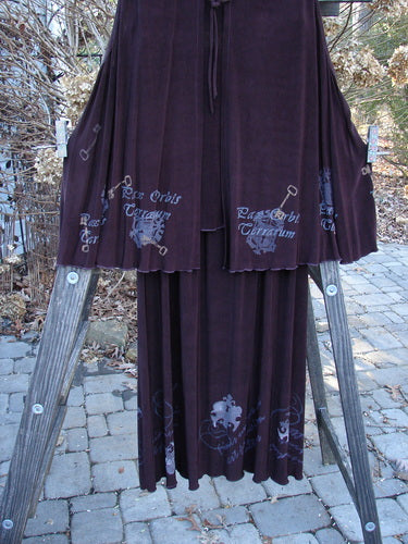 1999 Acetate Streamer Moonbeam Duo Key in Deep Burgundy, featuring a long A-line vest with silk tie closure and matching skirt on a wooden stand.