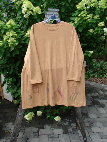 1998 Vegetable Tunic Top Bountiful Garden Ochre Size 2, featuring an A-line shape with a softly scooped neckline and a charming veggie motif hemline, displayed on a wooden ladder.