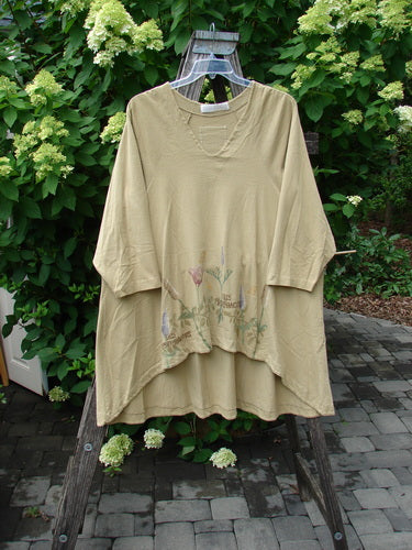 1998 Botanicals Bell Flower Top Iris Pseudacorus Seed Size 2, featuring a loose fit, elbow-length sleeves, V-neckline, and a botanical print near the hem, displayed on a wooden ladder.