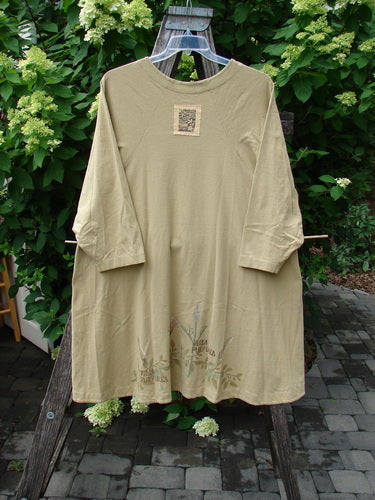 1998 Botanicals Bell Flower Top Iris Pseudacorus Seed Size 2, displayed on a wooden rack, features a belled A-line shape, three-quarter sleeves, and a botanical print near the hem.