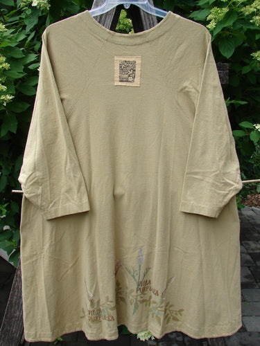1998 Botanicals Bellflower Top Iris Pseudacorus Seed Size 2 features a loose, olive-green A-line shape with three-quarter sleeves, a rounded neckline, and a vibrant floral print.