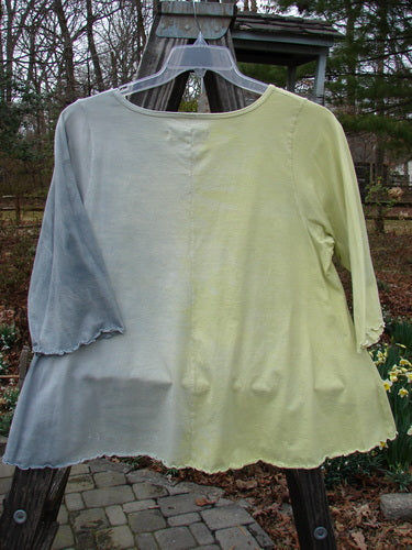 Barclay Three Quarter Sleeved A Line Tee Garden Friend Sunshine Size 0 displayed on a clothes hanger outdoors, showcasing its rounded and rolled neckline, flat edgings, and unadorned back.