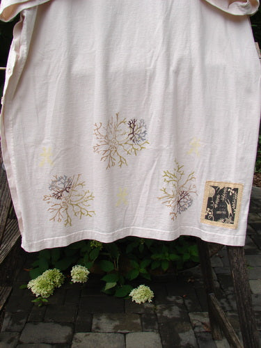 1997 Mauritius Top Sea Coral Powder OSFA draped over a wooden rail, showcasing its muted earth-toned coral prints and distinctive rectangular patch, embodying vintage Blue Fish Clothing's creative and expressive style.