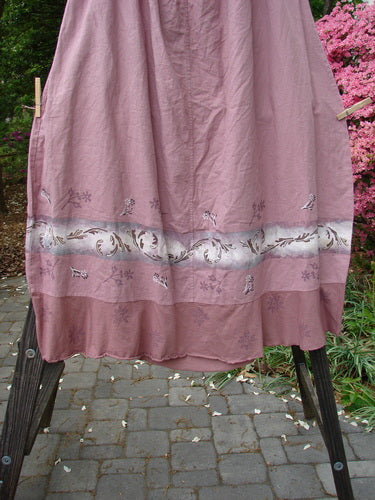 Barclay Linen Duet Skirt Falling Fern Dried Rose Size 2 hanging on a clothesline, showcasing its unique cotton linen blend, bell shape, and tiny floral and fern patterns.