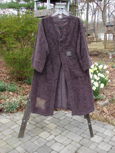 2000 Patched Upholstery Diwmach Coat Celtic Time Aubergine Size 0 displayed on an outdoor tree branch, highlighting its detailed damask paisley pattern, scalloped neckline, and belled sleeves.