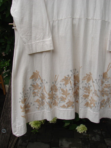 Barclay Deep V Neck Rear Banded Pocket Tunic Morning Garden Dew Size 1, featuring a lightweight, long-sleeved design with a muted floral print along the hem, hanging outdoors.