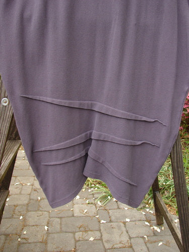 2000 NWT Thermal Awen Skirt with Larger Elastic Waistline on a wooden stand, highlighting its full elastic waistband and unique directional fabric folds.