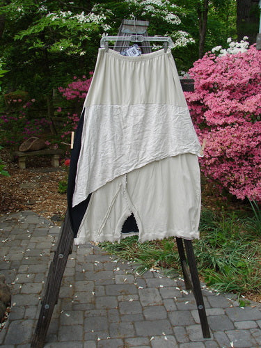 Barclay NWT Mixed Media Swatch Skirt Unpainted Black and Wash Size 2 displayed on a clothes rack, showcasing its layered textures, sectional panels, and full elastic waistline.
