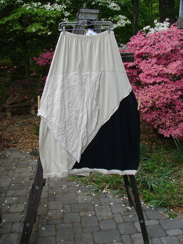 Barclay NWT Mixed Media Swatch Skirt Unpainted Black and Wash Size 2 hanging on a clothes rack, showcasing its layered textures and sectional panels.