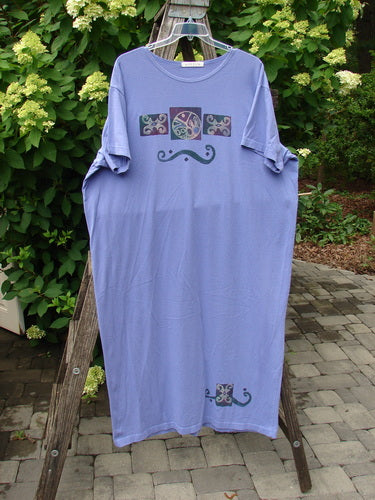 1997 Aquavella Dress Celtic Trio Skylark Size 2 features a lavender T-shirt dress with short sleeves, decorative block prints, wide scooped neckline, and tapered hem, displayed outdoors on a wooden ladder.