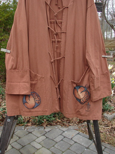 1998 Albion Hooded Jacket Coat Harvest Time Rockwood OSFA featuring a triangular front pocket design, wide lower sleeves, drop shoulders, front tie closures, and a cozy hood.
