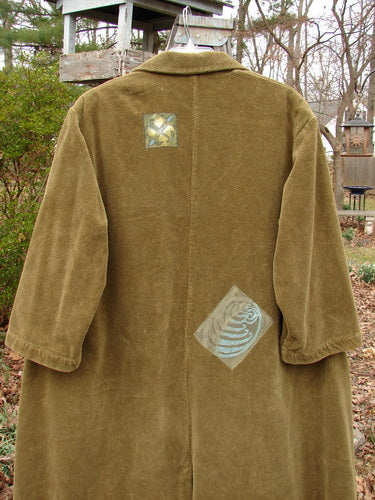 1998 Patched Tapestry Coat Forest Path Glazed Tile OSFA displayed on a hanger, featuring mixed forest path patches, large front pockets, stand-up collar, and vintage buttons.