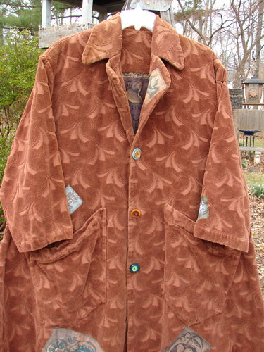 1998 Patched Tapestry Coat Bountiful Path Rockwood OSFA displayed on a hanger, featuring a stand-up collar, three buttons, two large front pockets, and intricate patchwork design.