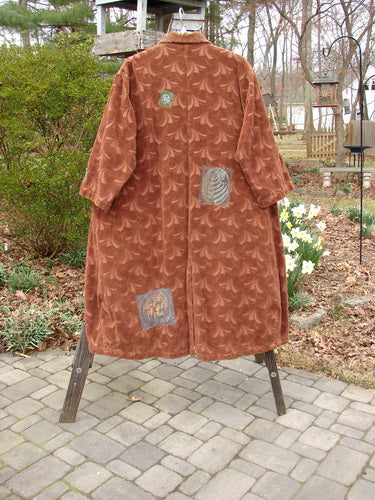 1998 Patched Tapestry Coat Bountiful Path Rockwood OSFA displayed on a rack, showcasing a rich, heavy textured cotton with intricate patch designs, large angular pockets, and a stand-up collar.