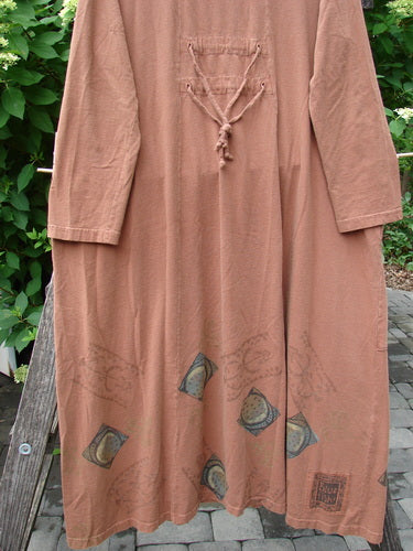 1998 Mandolin Dress Lucky Horseshoe Rockwood Size 2 features a loose fit with 3/4 sleeves, lace-up chest detail, and geometric motifs on the hem, hanging outdoors against a leafy garden backdrop.