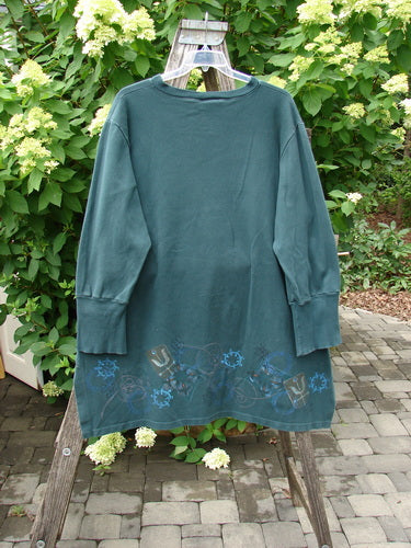 Barclay Interlock V Neck Vented Tunic Top Celtic Tumble Forest Teal Size 2 on hanger, featuring a ribbed neckline, flared hem with motifs, vented sides, and ribbed sleeves, showcasing cozy elegance.