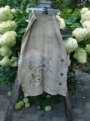 Barclay Crinkle Cotton Scarf Morning Fern Mottled Wheat OSFA, draped on a wooden ladder, features faint floral motifs and a crinkled texture, embodying the vintage elegance of Bluefishfinder.com's creative clothing line.