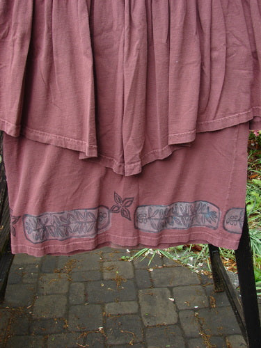 Close-up of the 1993 Picnic Dress Fern Boysenberry OSFA, showcasing its gently rounded V neckline and flirty flounce detail.