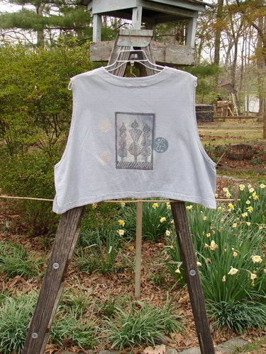 1994 Spruance Vest Topiary Solstice Blue OSFA displayed on a wooden ladder, showcasing its unique crop layering and dual paper button closure, with a topiary-themed rear paint.