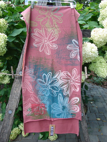 Barclay NWT Wide Sectional Scarf Daisy Desert Rose OSFA drapes elegantly on a rustic ladder, showcasing its daisy print and sweet unfinished rolled edges, embodying Bluefishfinder.com's vintage, creative spirit.