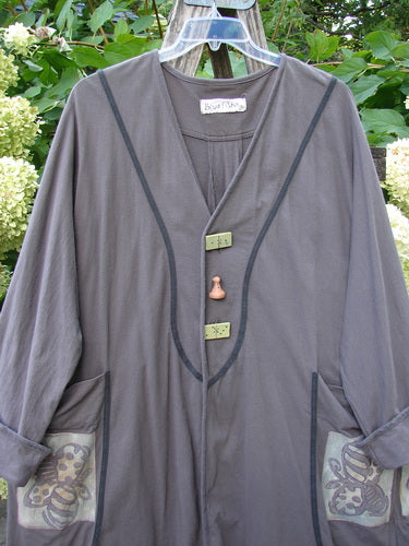 1998 Tiddly Winks Jacket Butterfly Madeira Size 2, featuring a deep V-neck with black piped trim, toggle closures, and bee-motif patch pockets, displayed outdoors against foliage, embodying Bluefishfinder.com's vintage charm.