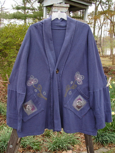 1995 Reprocessed Deco Jacket Greyhound Royal Orchid OSFA features a blue cardigan with floral patterns, drop dolman shoulders, deep V neckline, and oversized painted pockets, showcasing the vintage Blue Fish Clothing style.