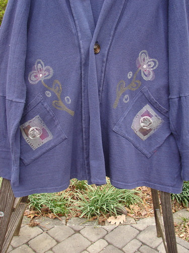 1995 Reprocessed Deco Jacket Greyhound Royal Orchid OSFA with floral patterns and buttons, featuring long sleeves, deep V neckline, drop dolman shoulders, and oversized painted diagonal pockets.