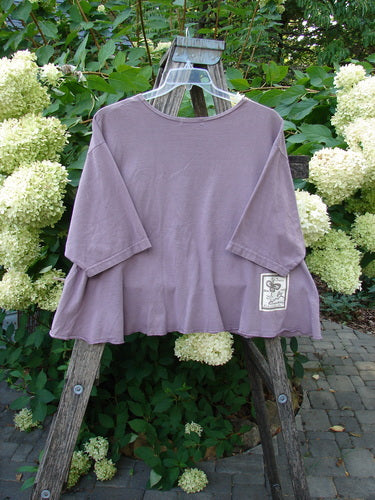 Barclay PMU Patched Short Sleeved Crop A Line Tee Dark Mallow Size 2, featuring a rounded neckline, short sleeves, and a unique alligator-themed patch, displayed on a wooden ladder with hydrangeas in the background.