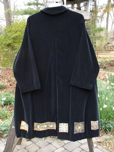 1999 Velveteen Poet's Coat Holiday Celtic Black Size 1: A black coat with gold designs, featuring oversized vintage buttons, a folded collar, and two front pockets.
