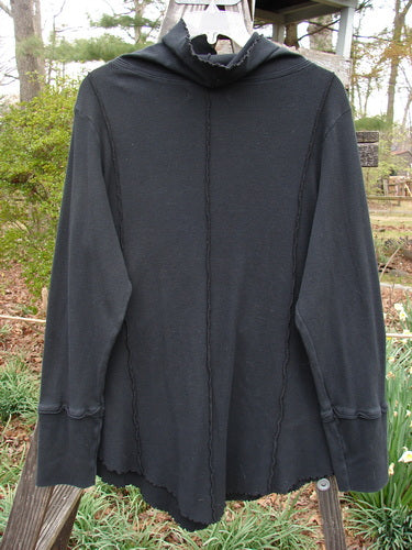 Barclay Lightweight Thermal Cowl Neck Roo Tunic Unpainted Black Size 1 displayed on a hanger, showcasing a flop turtleneck, ribbed waffle cuffs, and exterior stitchery details.