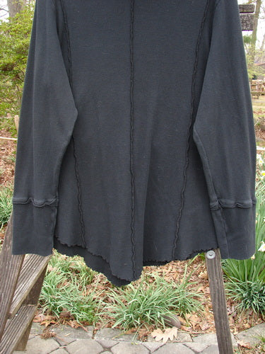 Black Barclay Lightweight Thermal Cowl Neck Roo Tunic on a wooden stand, featuring exterior stitchery, curly edgings, ribbed waffle cuffs, flop turtleneck, and lower drop kangaroo tunnel pocket.