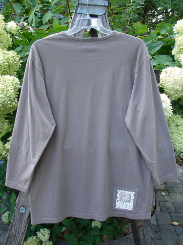 1999 Long Sleeved Vented Tee Orchid Sprig Shale Size 1 displayed on a wooden ladder, featuring a thicker ribbed neckline, vented sides, orchid sprig theme paint, and signature Blue Fish patch.