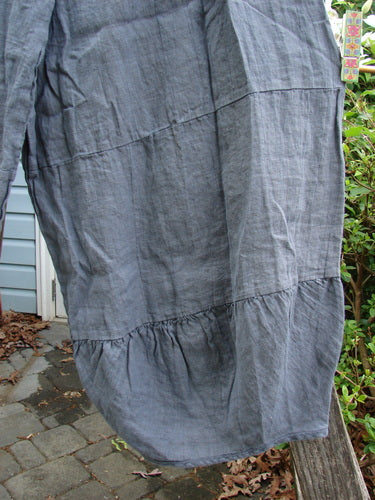 Barclay Linen Meadow Pant Unpainted Cross Dye Steel Size 0, showcasing a flowy silhouette with full elastic waist and gathered horizontal panels, perfect for spring or summer wear, in lightweight cotton linen.