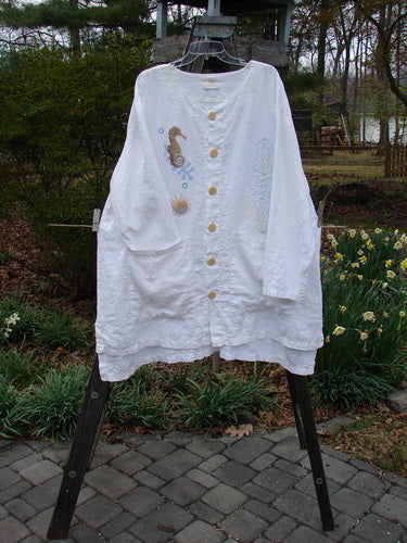 2000 Linen Beach Cardigan Seahorse White Size 2 featuring deep front pockets, oversized textured buttons, A-line sweep, shirt tail hemline, and seahorse-themed paint, displayed on a rack.