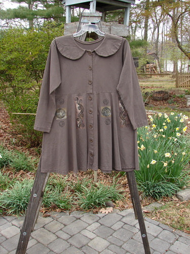 1994 Poppy Dress Belief Spirit Magic Humus Size 1 displayed on a rack, featuring a rounded collar, vintage buttons, empire waist, and a swingy lower skirt with detailed paint designs.