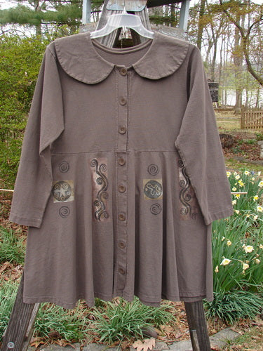 1994 Poppy Dress Belief Spirit Magic Humus Size 1 on a clothes rack, featuring a rounded collar, vintage buttons, and detailed design, perfect condition with a small spot on the lower skirt.