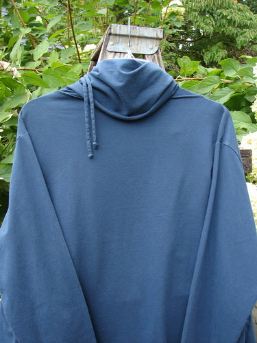 Barclay Cotton Lycra Gather Collar Open Front Jacket draped on a wooden ladder, showcasing its unique neckline and flowing hemline, set against a lush garden backdrop.