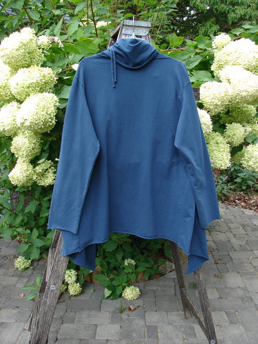 Barclay Cotton Lycra Gather Collar Open Front Jacket Unpainted Navy Size 2 draped on a ladder, showcasing its asymmetrical hem, dual-paneled pockets, and unique drawcord neckline, epitomizing Bluefishfinder's vintage style.