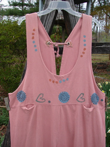 1993 Railroad Overall Pant Jumper Hearts Dried Rose Size 1 displayed on a wooden hanger outdoors, featuring a paneled design, deep neckline, tiny front pockets, and a rear waistline drawcord.