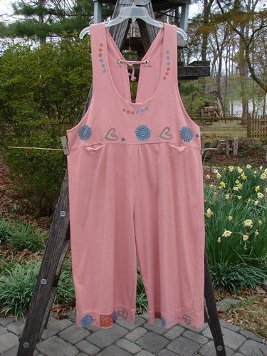 1993 Railroad Overall Pant Jumper Hearts Dried Rose Size 1 displayed on a wooden ladder, featuring heart and swirl patterns, deep oval neckline, tiny front pockets, and whipstitched metal grommets.