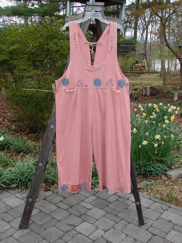 1993 Railroad Overall Pant Jumper Hearts Dried Rose Size 1 hung on a wooden rack, showcasing floral patterns, deep oval neckline, and front pockets.