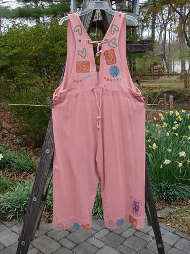 1993 Railroad Overall Pant Jumper Hearts Dried Rose Size 1 displayed on a wooden ladder, featuring whipstitching on metal grommets, deep oval neckline, and dual metal grommet rear accent with rope cording.