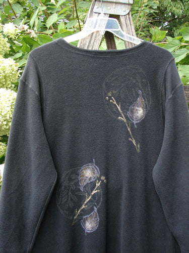 1998 Heavy Berber Kindlewood Tunic Leaf Sprig Black OSFA displayed on a hanger, featuring stylized botanical motifs on long sleeves and pocketed panels, set against a natural backdrop.